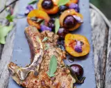Délicieuse côte de veau barbecue, servie avec des abricots rôtis et des cerises, garnie de sauge fraîche.