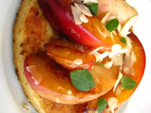 Tranches de fruits grillés sur pain toasté, garnies d'amandes effilées et de menthe.