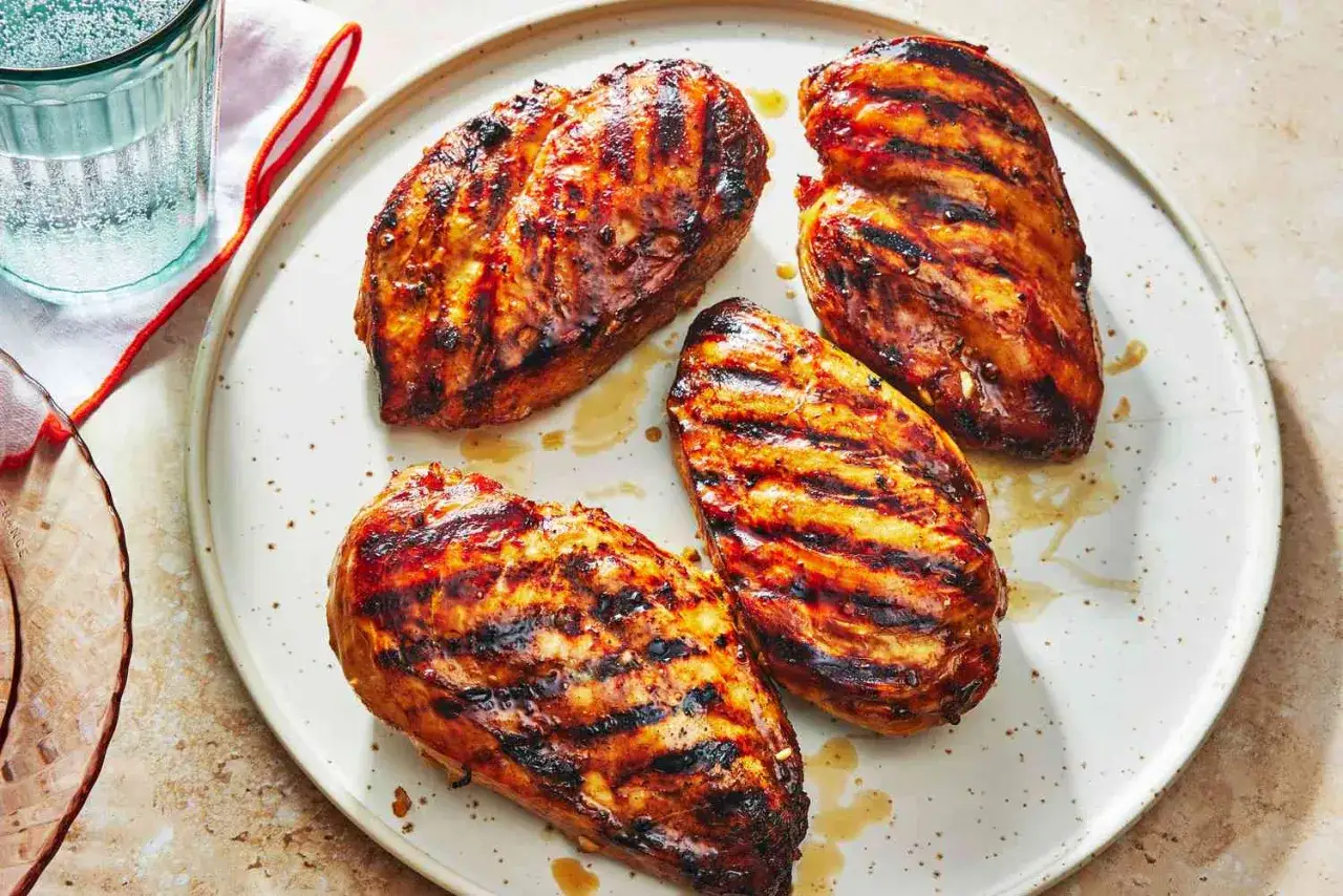 Quatre poitrines de poulet grillées, juteuses et caramélisées, parfaites pour savoir que faire avec un barbecue.